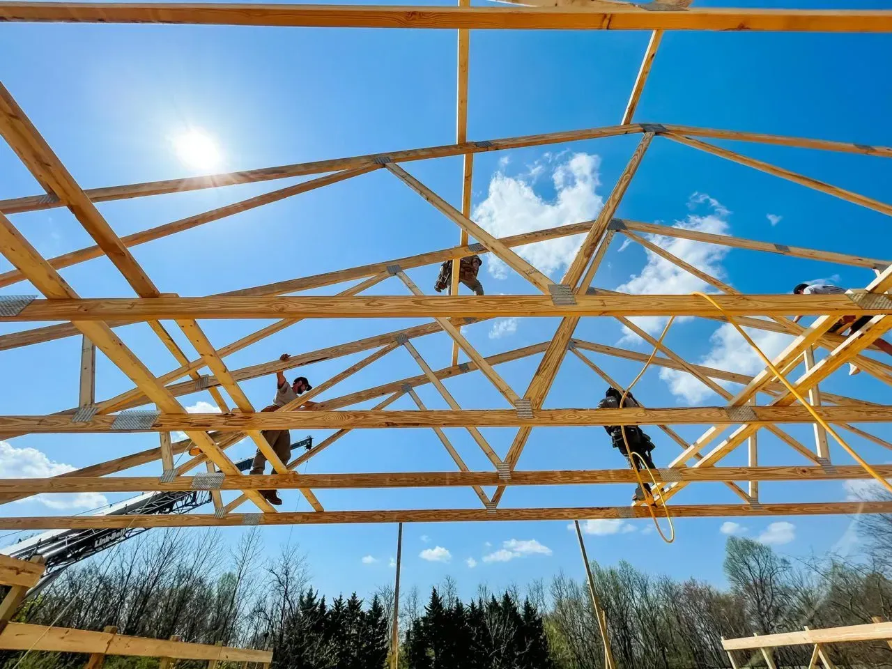 A group of people are working on a wooden structure.