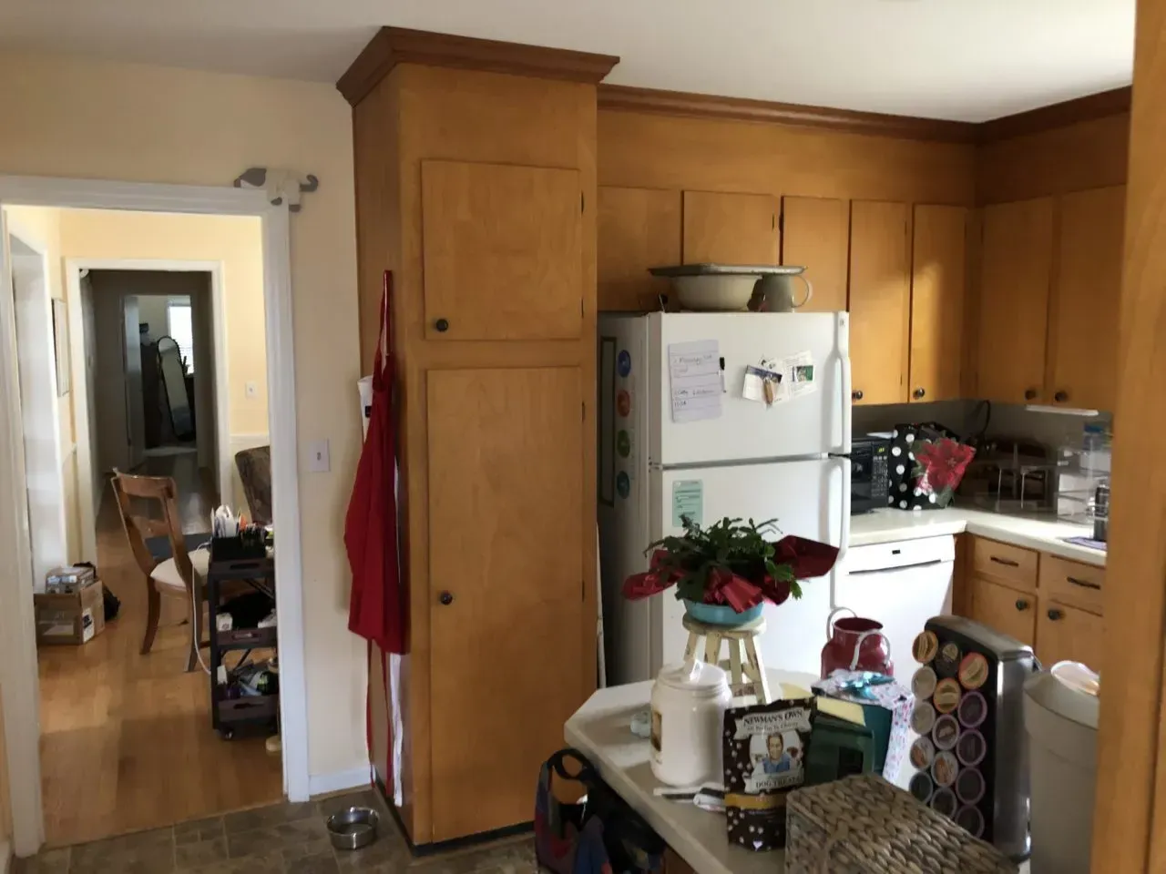 A kitchen with wooden cabinets and a white refrigerator