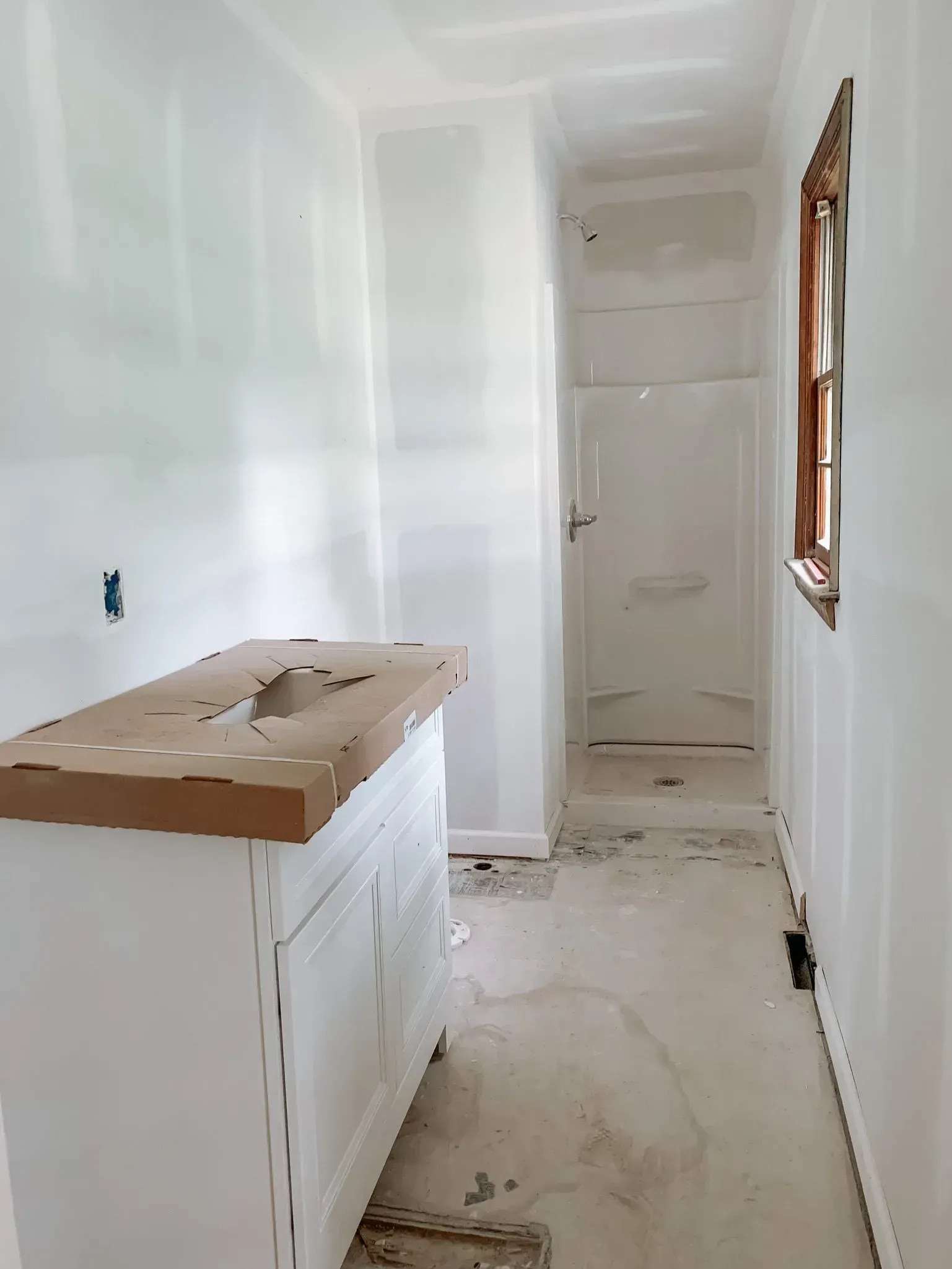 A bathroom under construction with a sink and a window.
