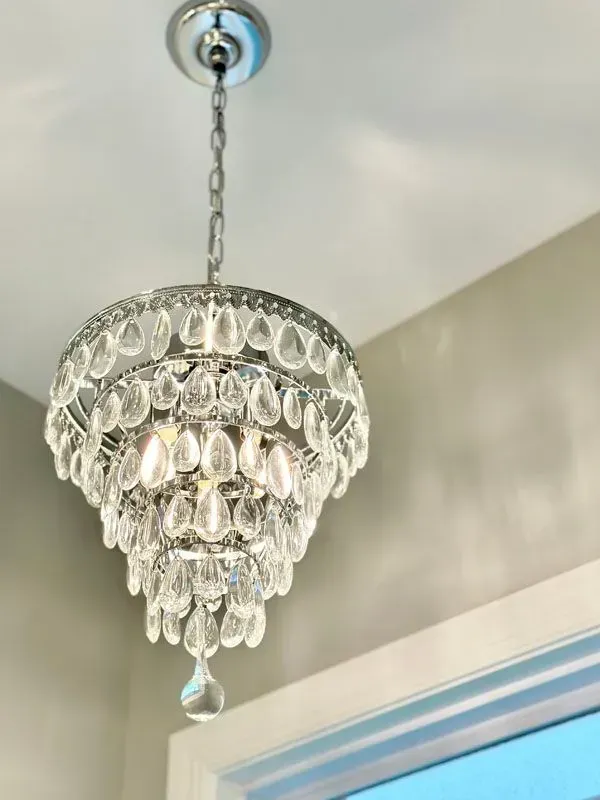 A chandelier is hanging from the ceiling in a room.