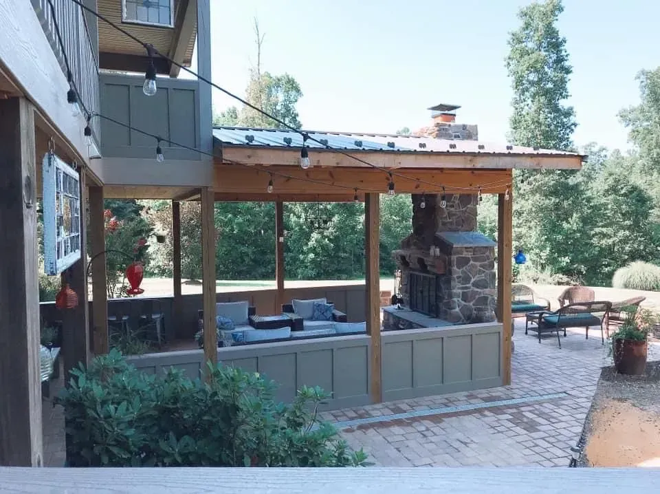 A patio with a fireplace and a covered patio area