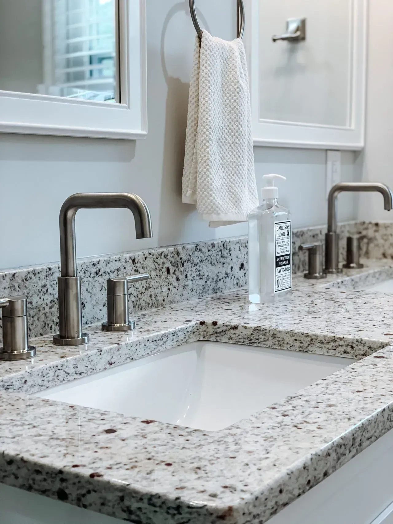 A bathroom with two sinks and a mirror.