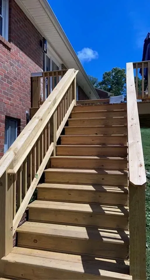 A wooden deck with stairs leading up to it.