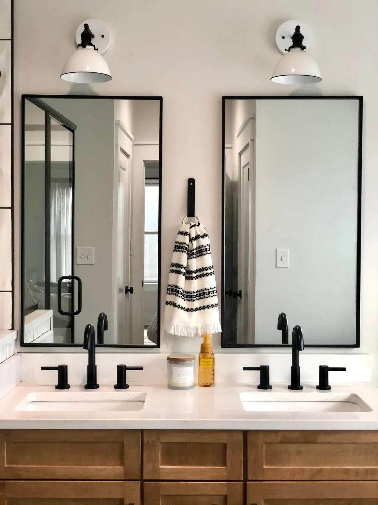 A bathroom with two sinks and two mirrors.