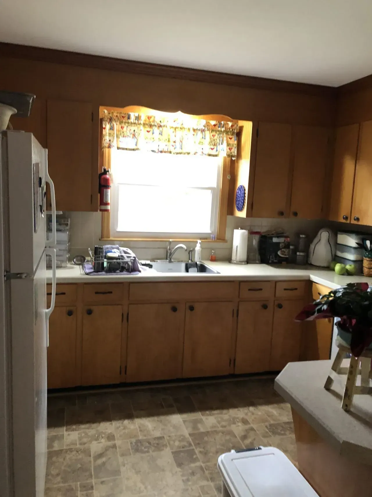 A kitchen with wooden cabinets and a white refrigerator