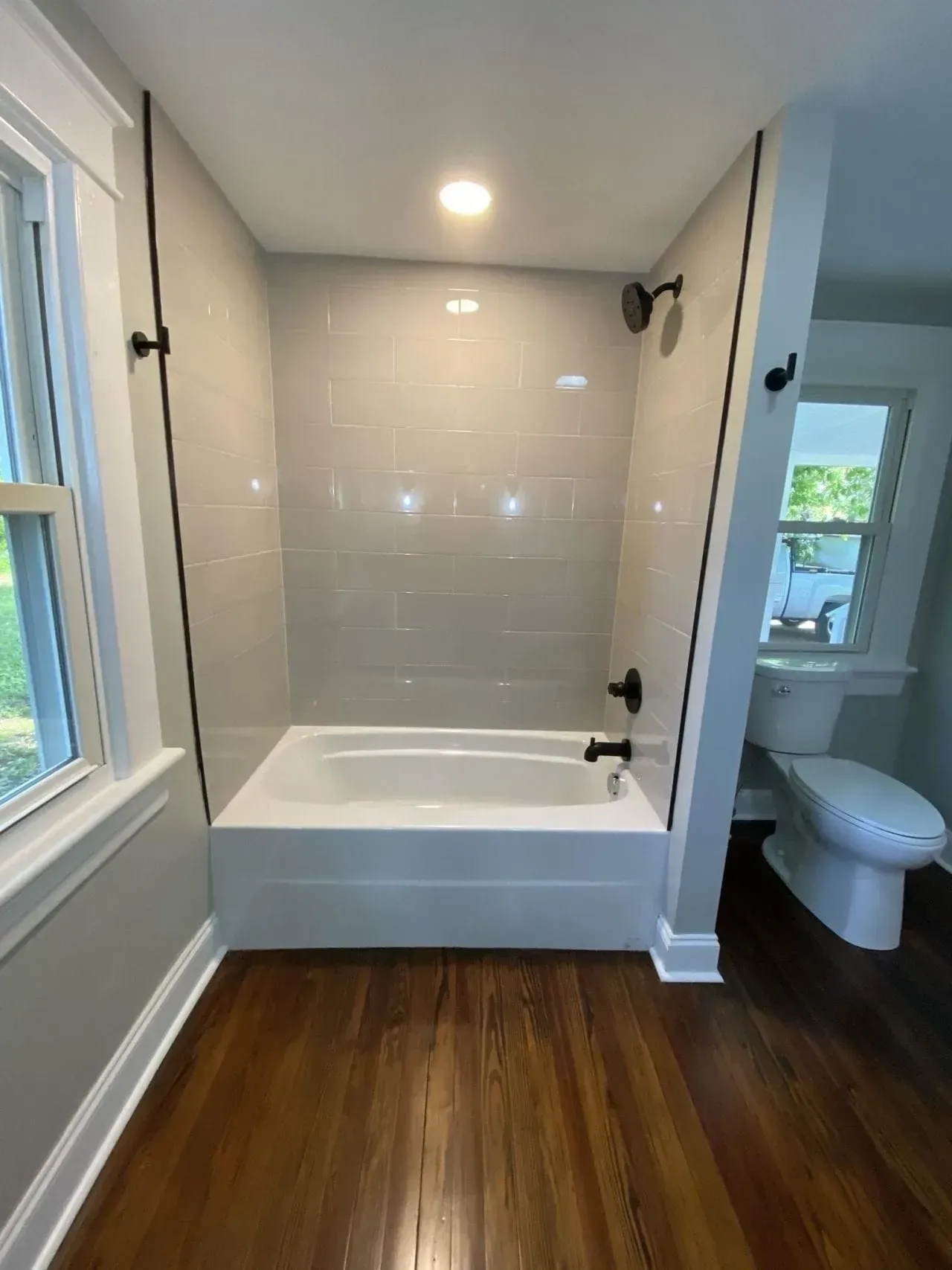 A bathroom with a bathtub , toilet , and shower.