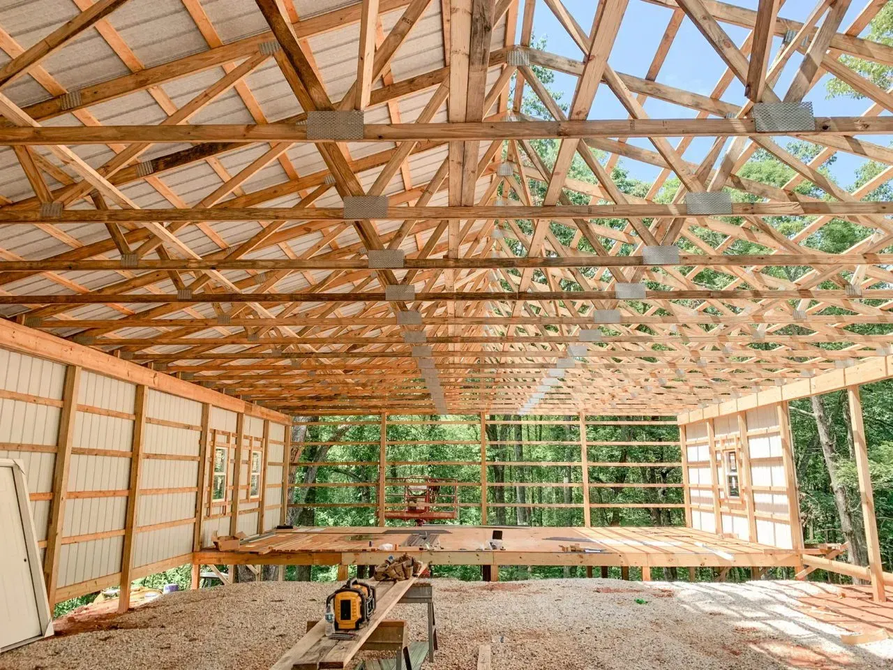 The inside of a building under construction with a wooden roof.