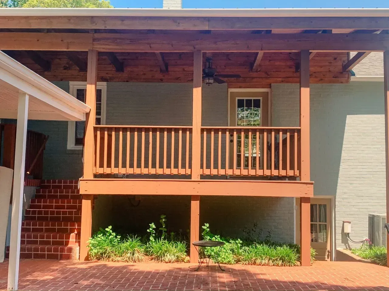 A house with a large wooden porch and stairs