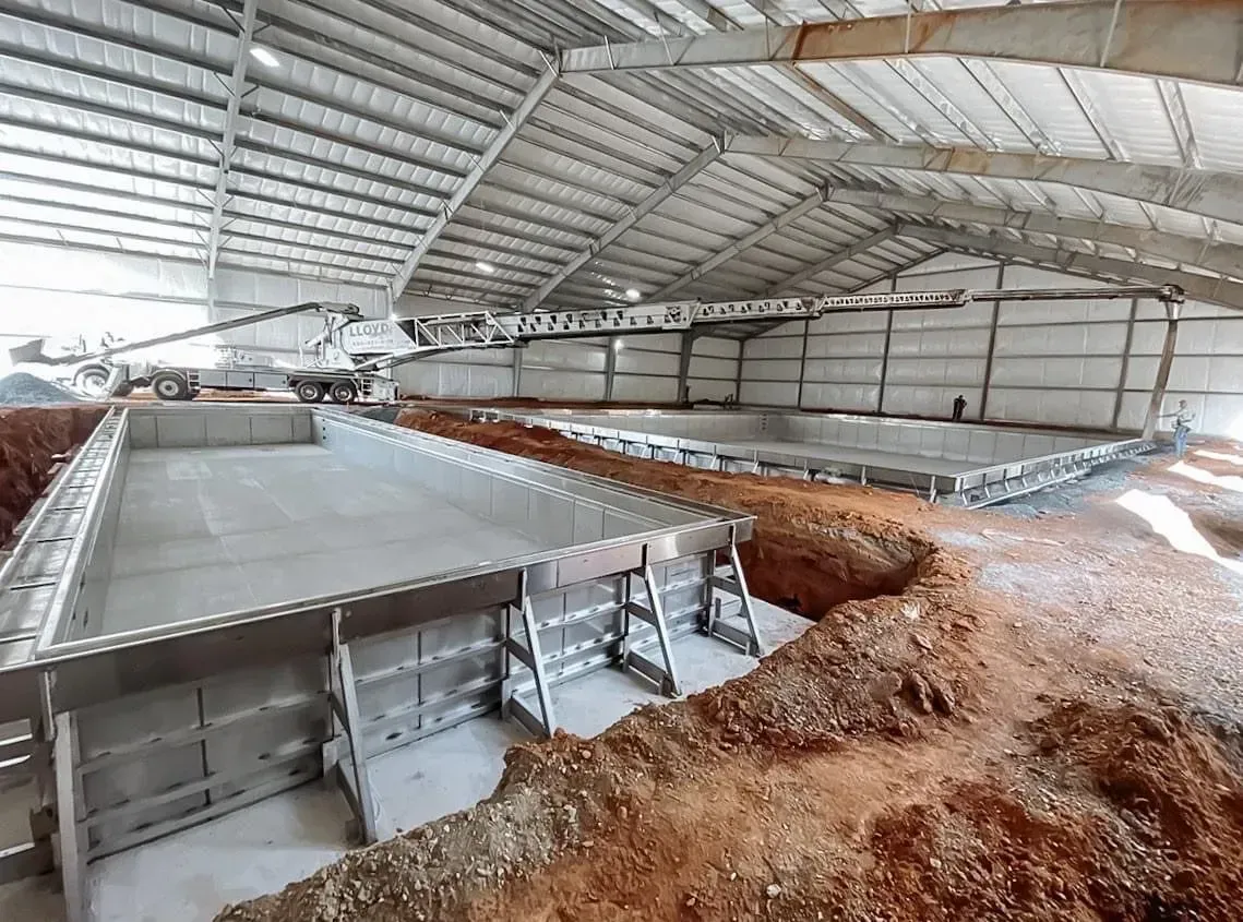A large building under construction with a lot of dirt on the ground.