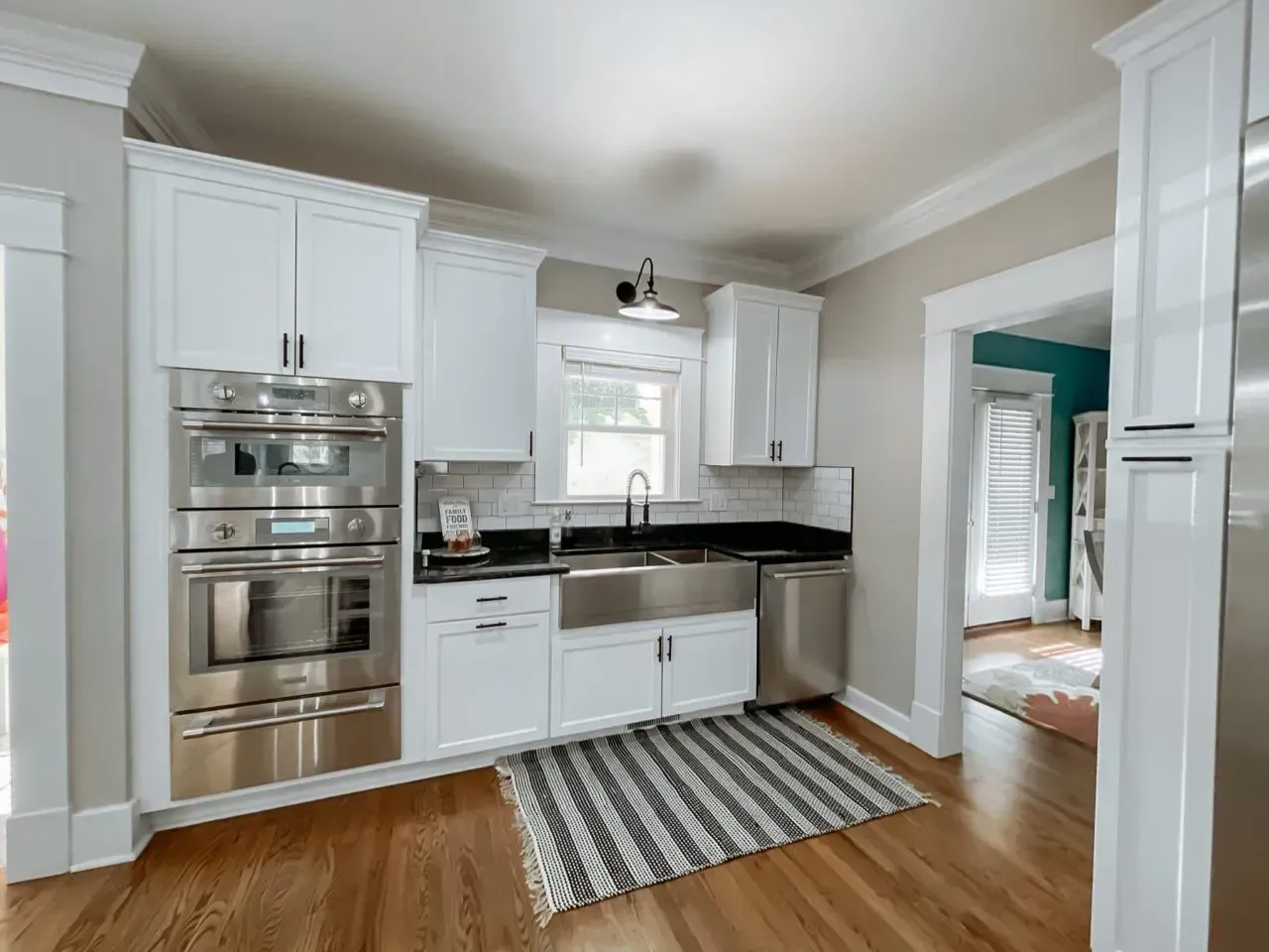 A kitchen with white cabinets and stainless steel appliances
