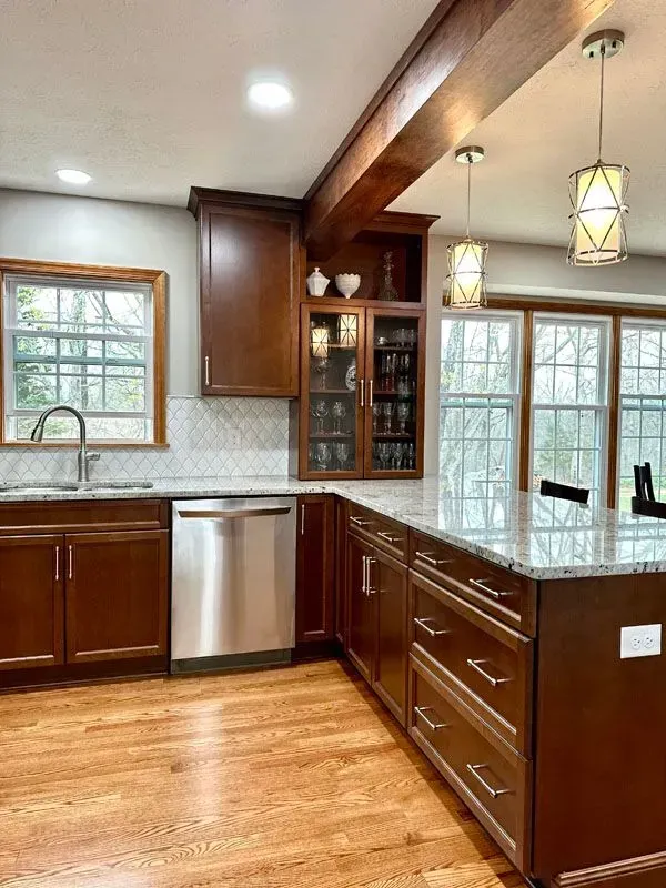 A kitchen with stainless steel appliances and wooden cabinets