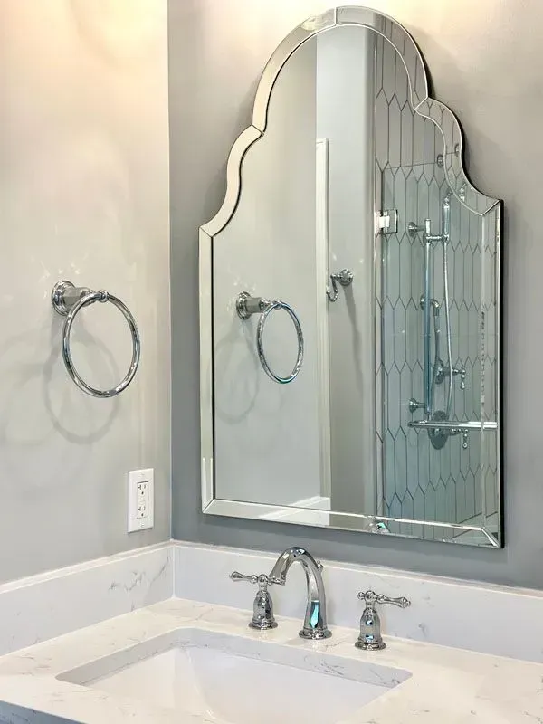 A bathroom with a sink and a mirror on the wall.