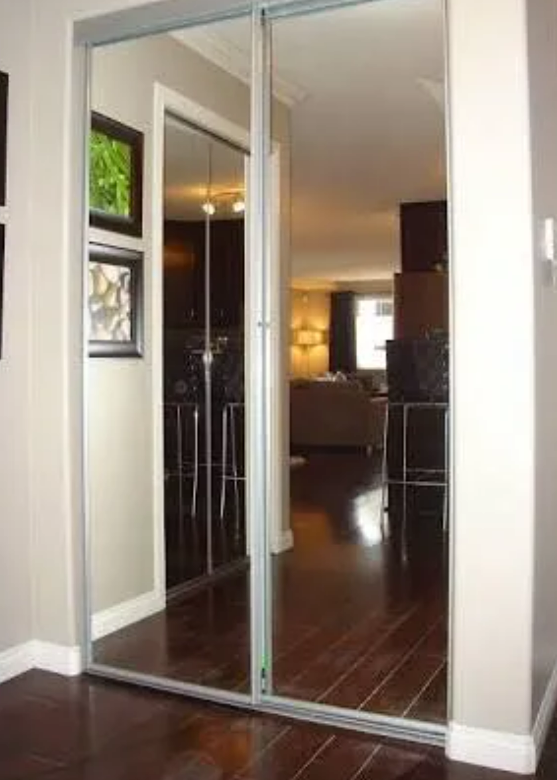 Mirrored Sliding Closet Doors Reflecting a Living Room — Alcando Renovations and Maintenance In Bobin, NSW