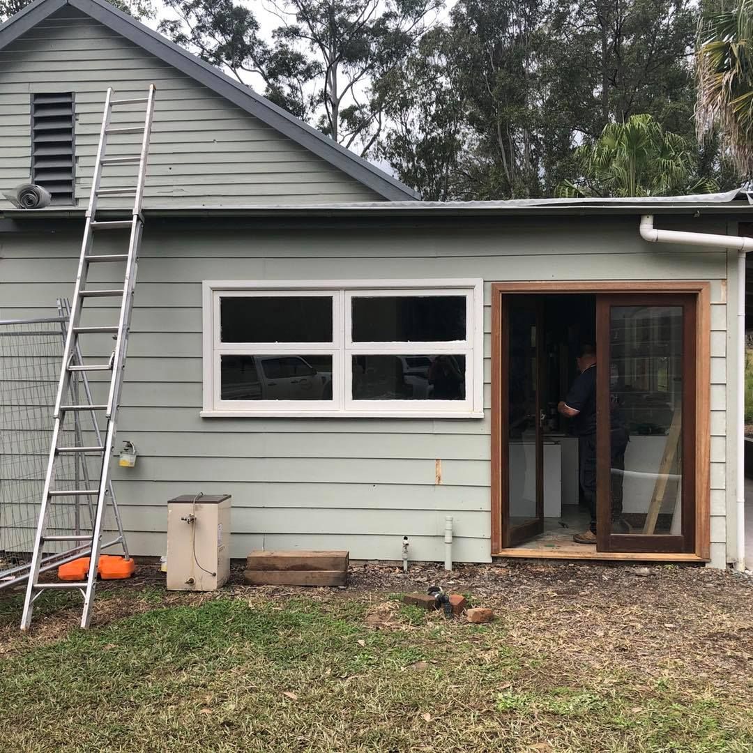Exterior of a Light Green Building With a Ladder — Alcando Renovations and Maintenance In Harrington, NSW