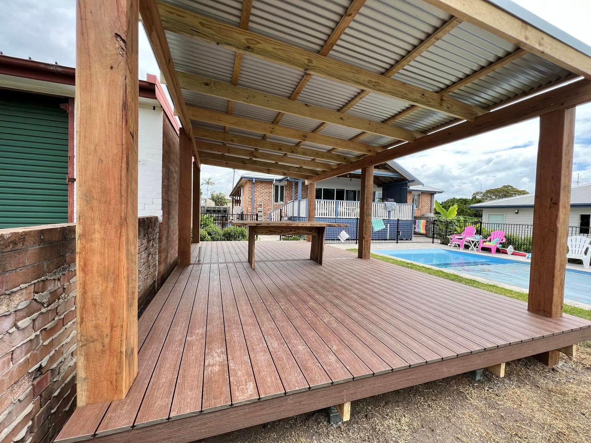 Wooden Deck With Pergola, Table, and Pool in Background — Alcando Renovations and Maintenance In Harrington, NSW