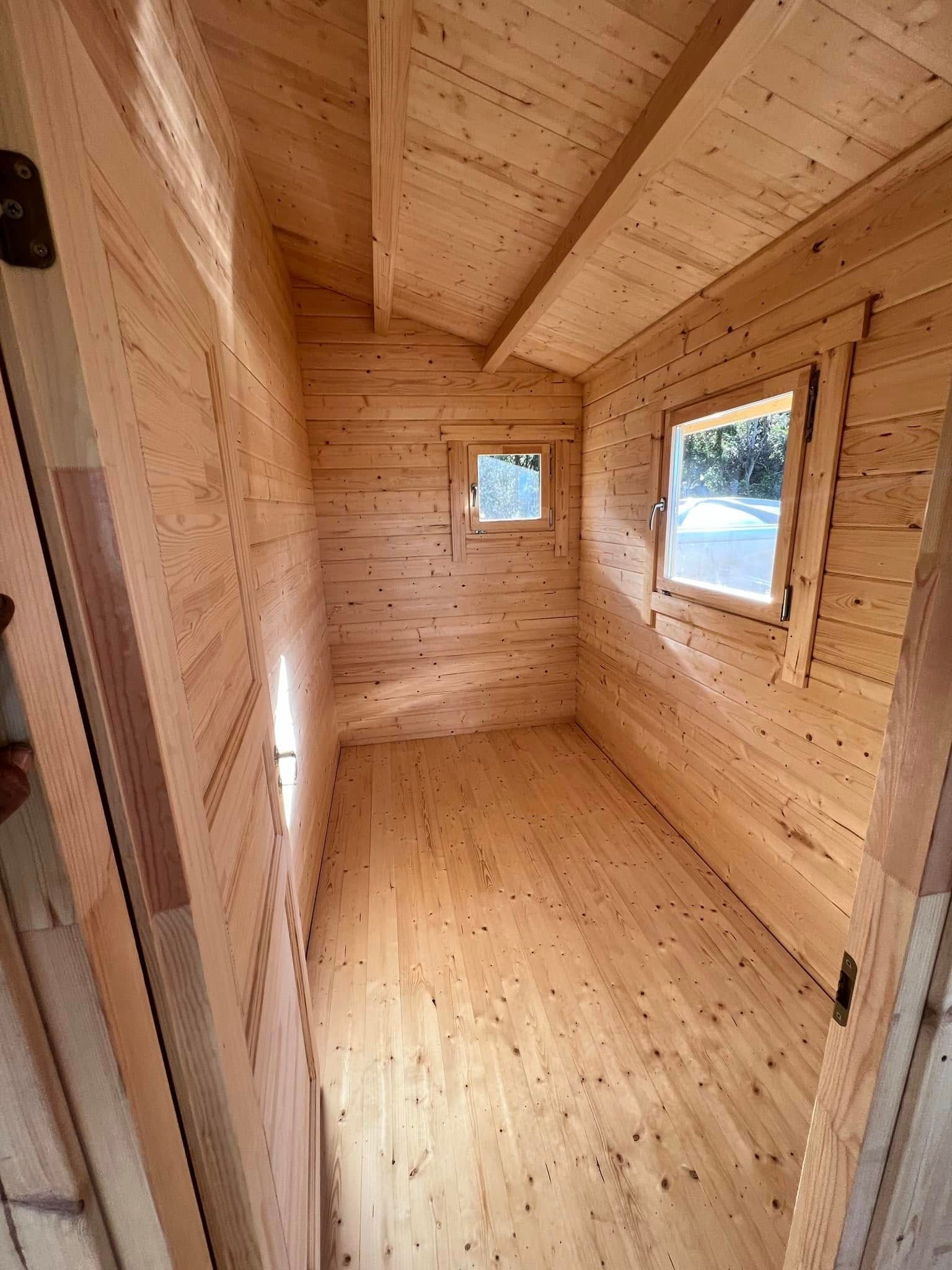 Wooden Interior of a Small Cabin With a Sloped Ceiling — Alcando Renovations and Maintenance In Taree, NSW