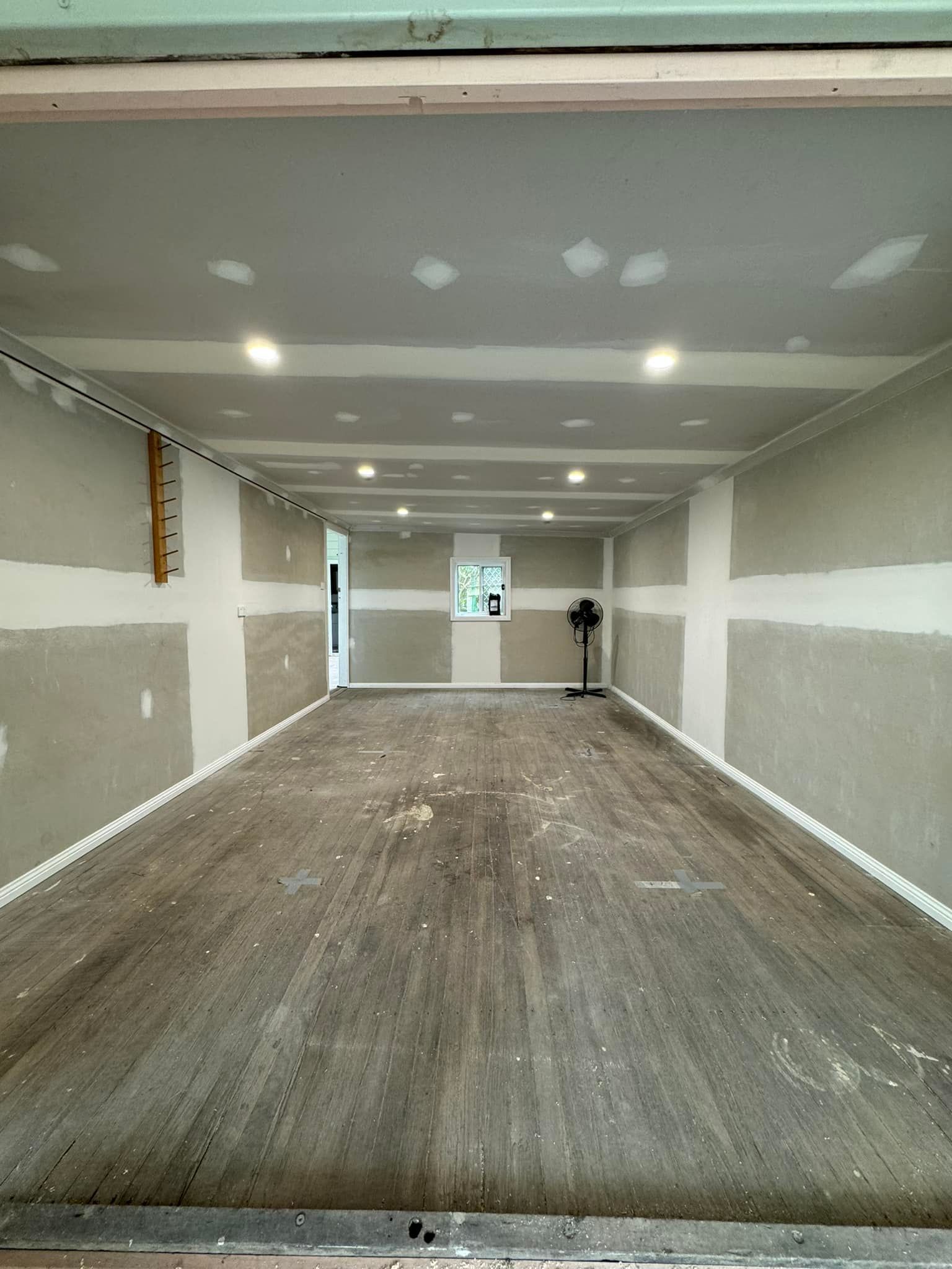 Room With Unfinished Walls And Hardwood Floor — Alcando Renovations and Maintenance In Forster, NSW