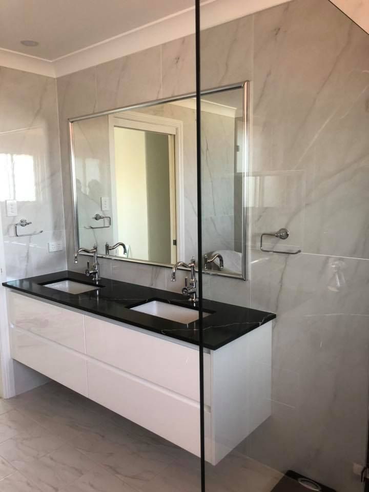 Modern White Bathroom Vanity With Black Countertop — Alcando Renovations and Maintenance In Wingham, NSW