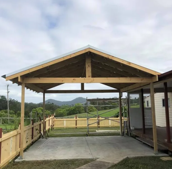Wooden Carport With Concrete Floor, Overlooking a Fenced Yard — Alcando Renovations and Maintenance In Forster, NSW