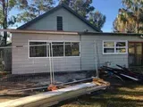 Gray House Under Construction, With Windows and a Gabled Roof — Alcando Renovations and Maintenance In Bobin, NSW