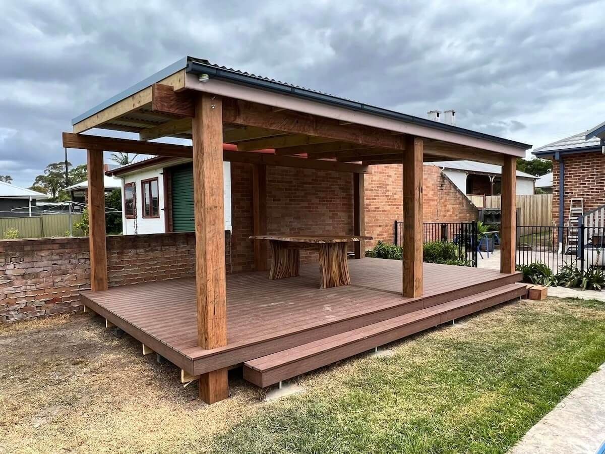 Wooden Pergola With Deck in a Yard, Against a Brick Wall — Alcando Renovations and Maintenance In Bobin, NSW