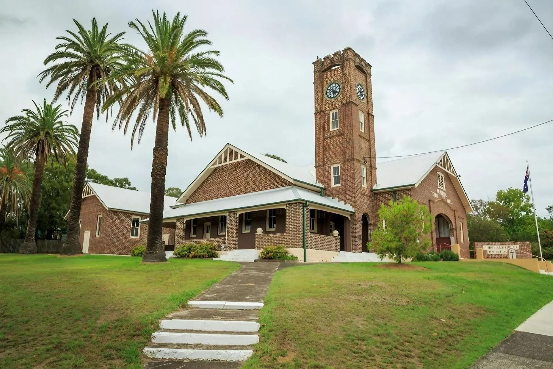 Stone Church With Clock Tower, Palm Trees in Front — Alcando Renovations and Maintenance In Bobin, NSW