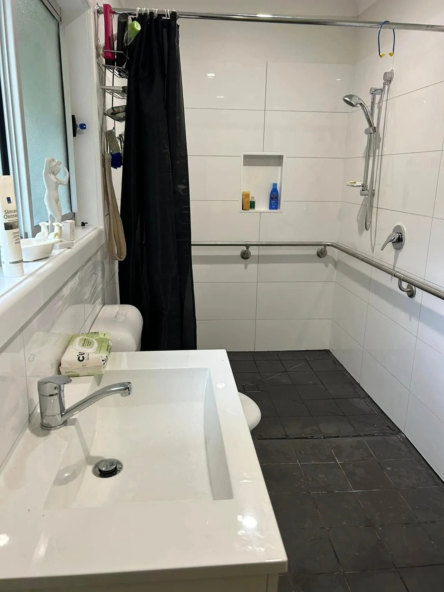Bathroom With White Tile Walls, Accessible Shower, and Sink — Alcando Renovations and Maintenance In Harrington, NSW