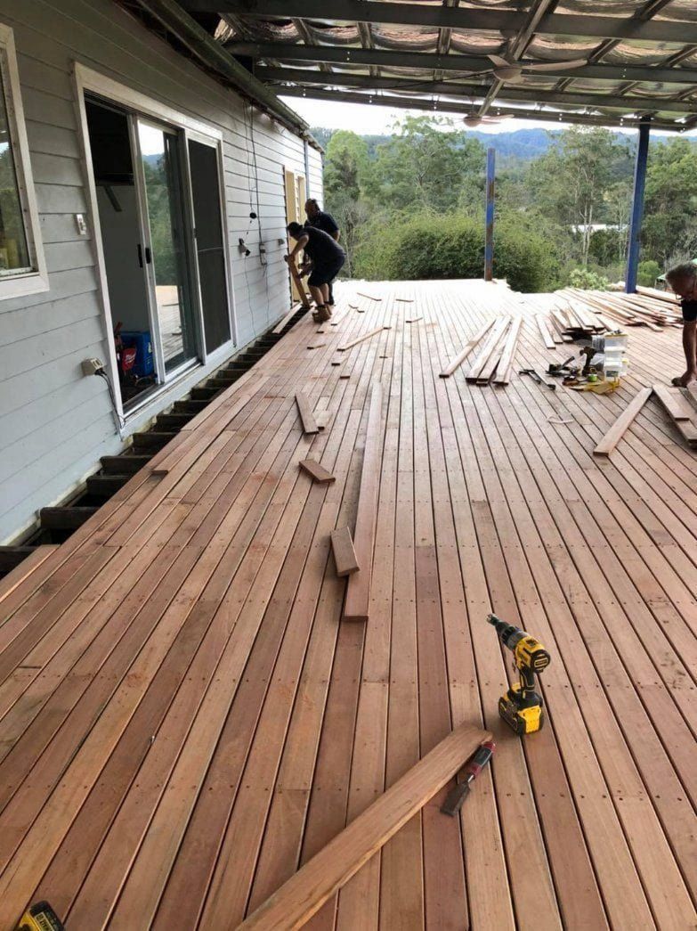 Wooden Deck Construction in Progress With Workers, Tools, and House — Alcando Renovations and Maintenance In Bobin, NSW