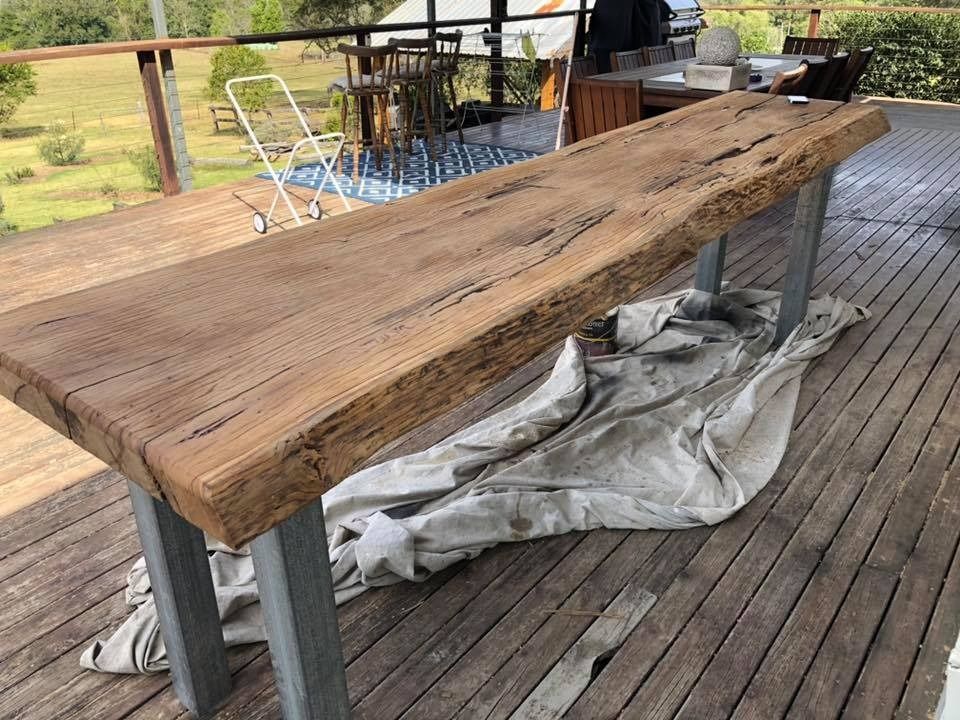 Long Wooden Bar Table With Natural Edge on Metal Legs, on a Wooden Deck — Alcando Renovations and Maintenance In Bobin, NSW