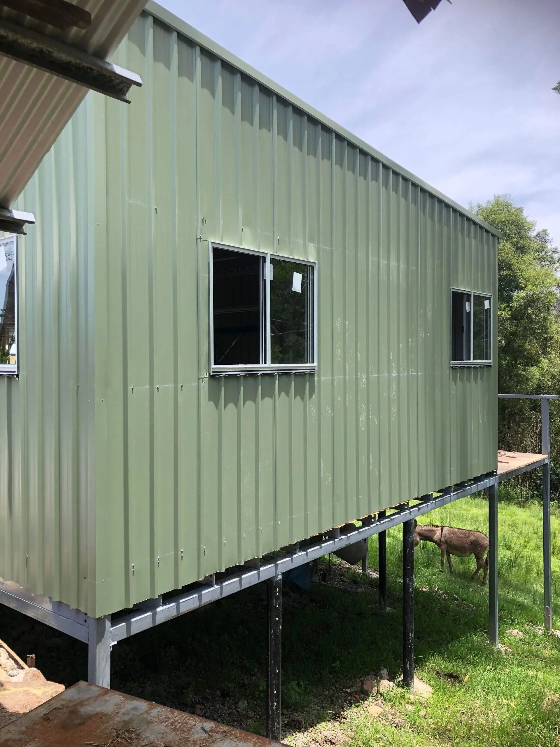 Green Metal Building With White-framed Windows — Alcando Renovations and Maintenance In Bobin, NSW