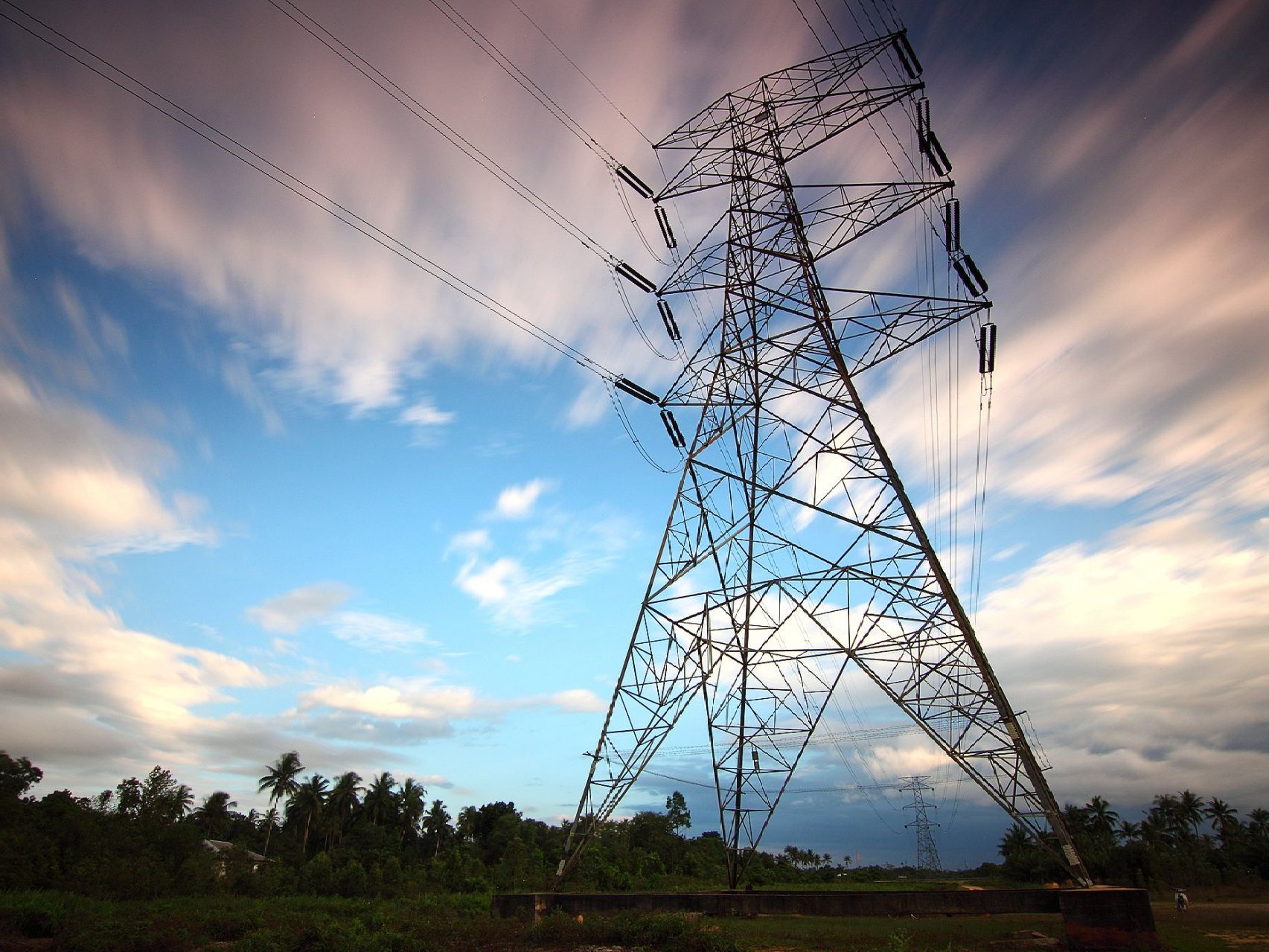 A power tower with a cloudy sky in the background
