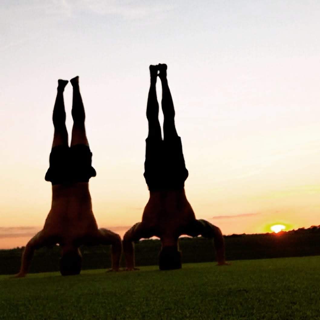 Coaches at Frontline Functional Fitness performing a headstand balance