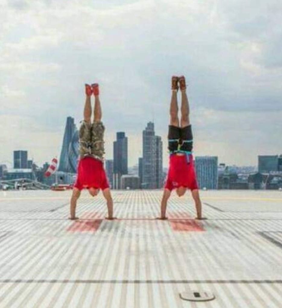 Coaches at Frontline Functional Fitness performing a handstand balance