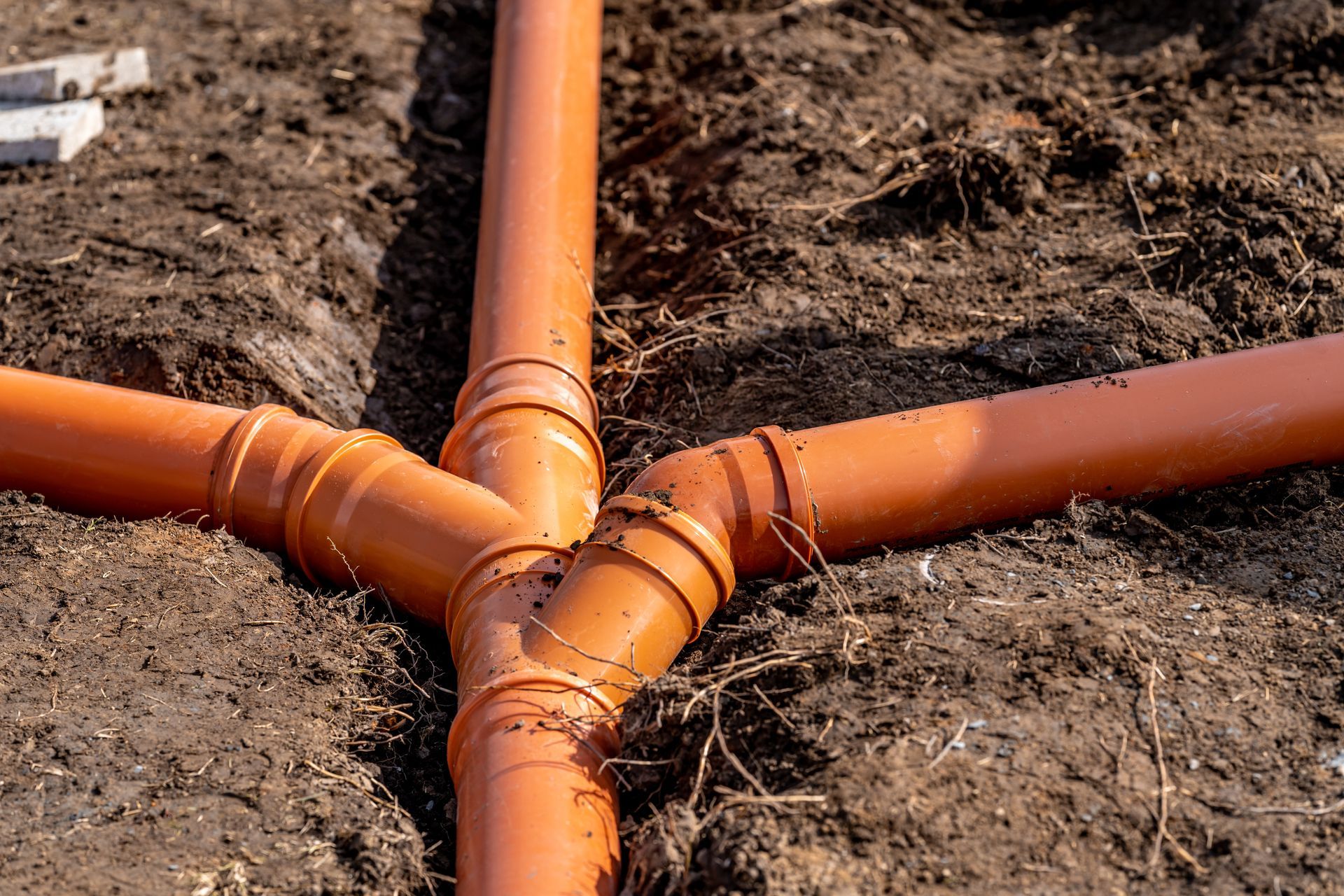 a bunch of pipes are connected to each other in the dirt .