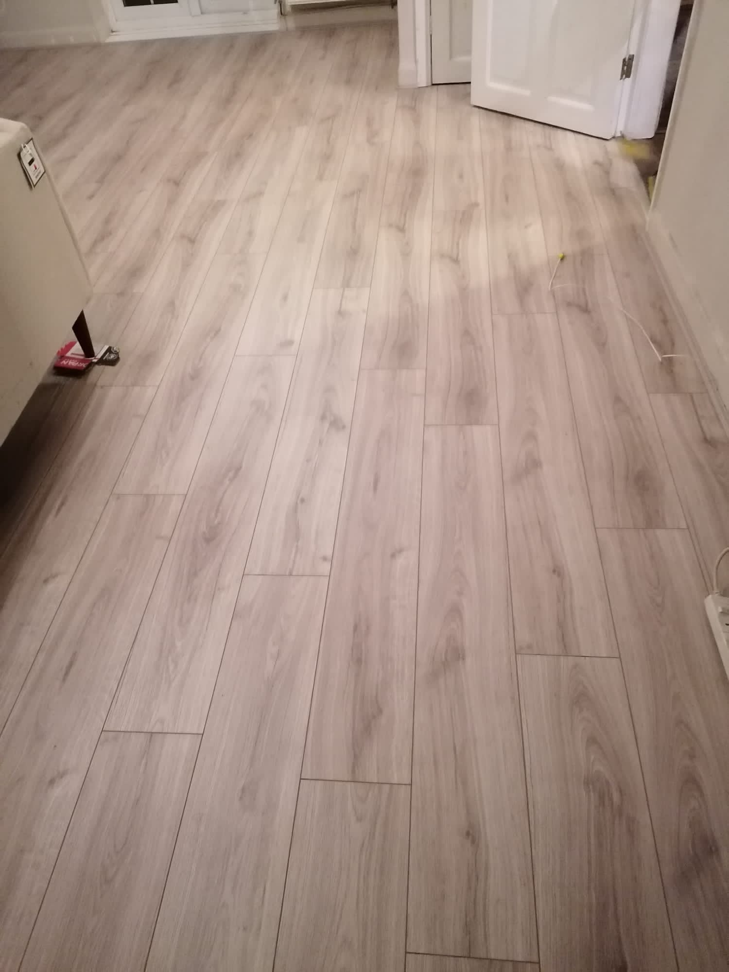 A room with a wooden floor and a door.