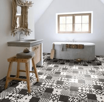 A bathroom with a bathtub , sink and mirror.