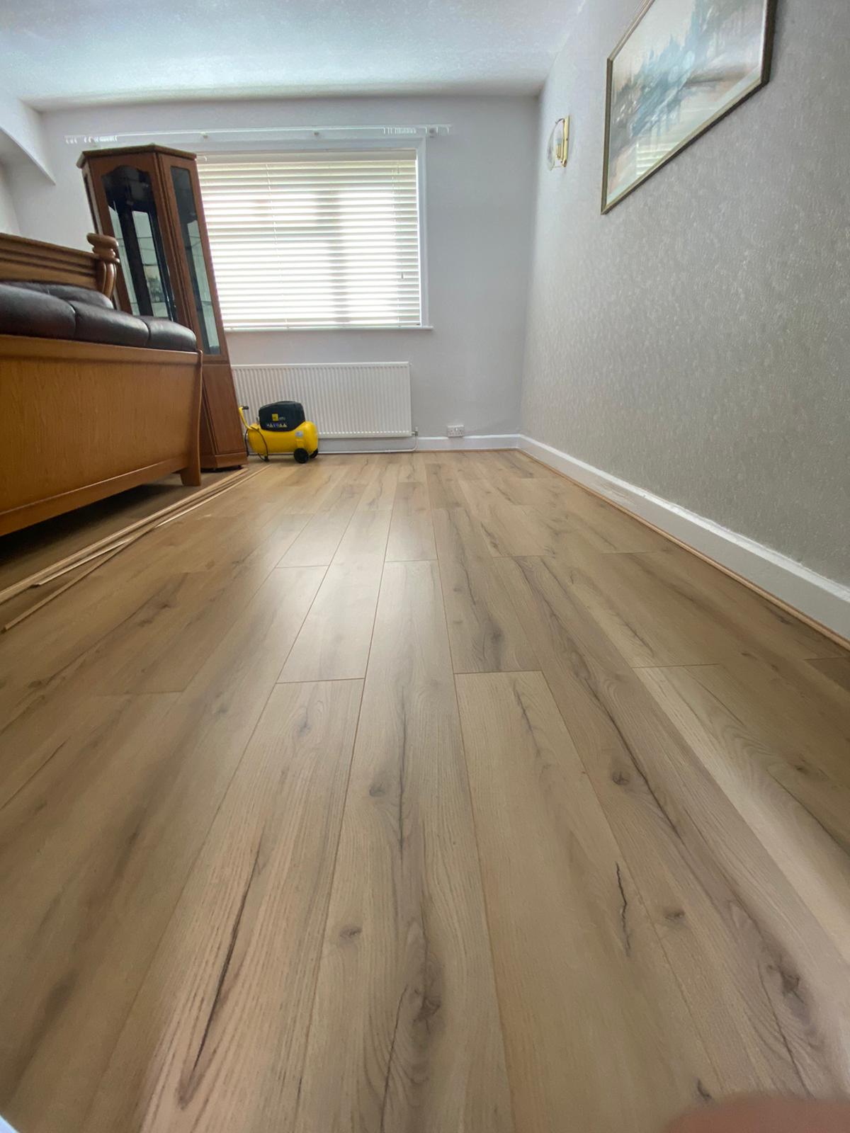 A living room with a wooden floor and a yellow toy.