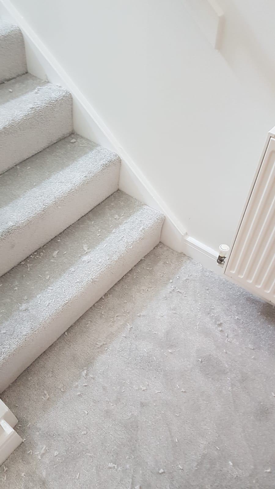 A close up of a staircase with a radiator next to it.