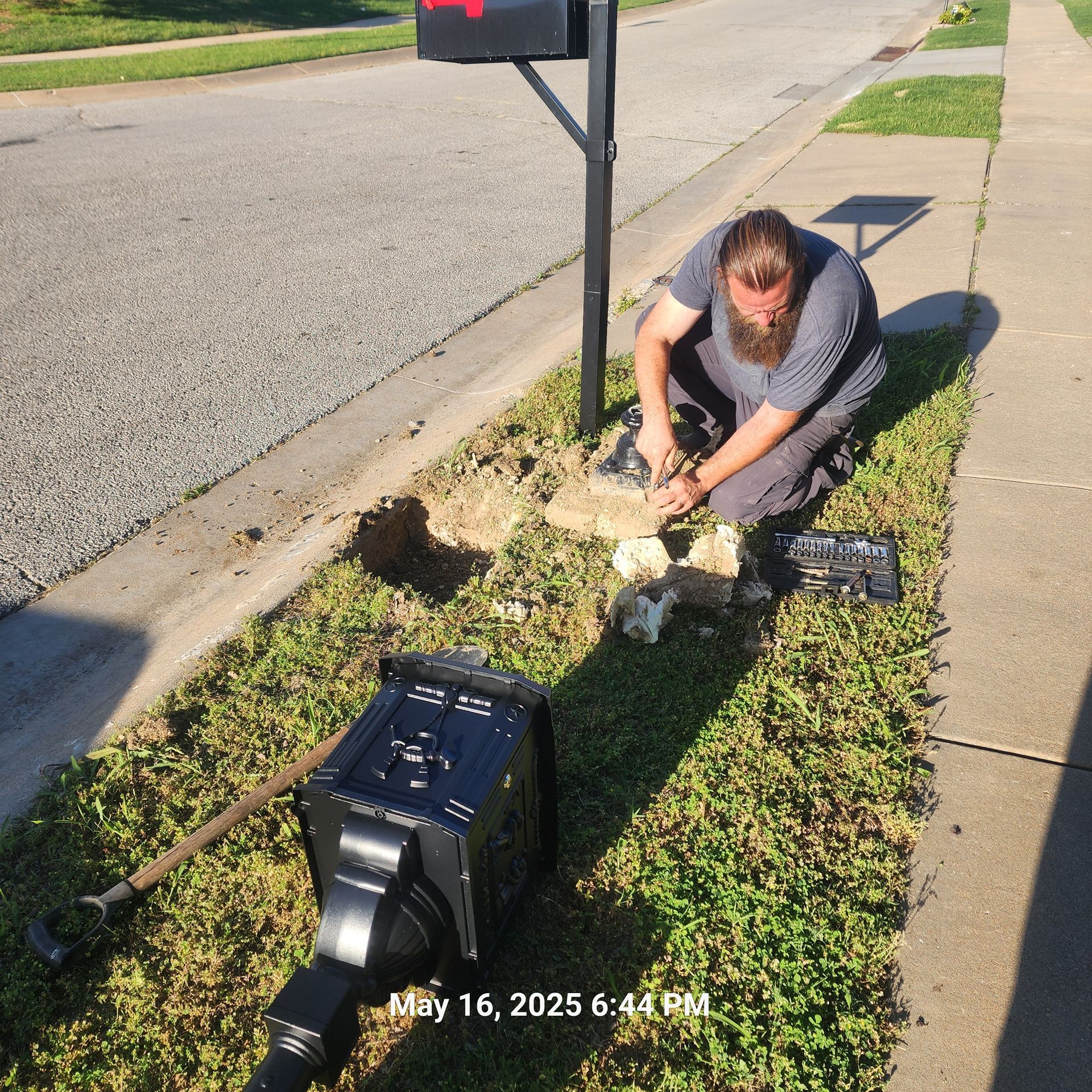 A man is working on a mailbox on may 16th