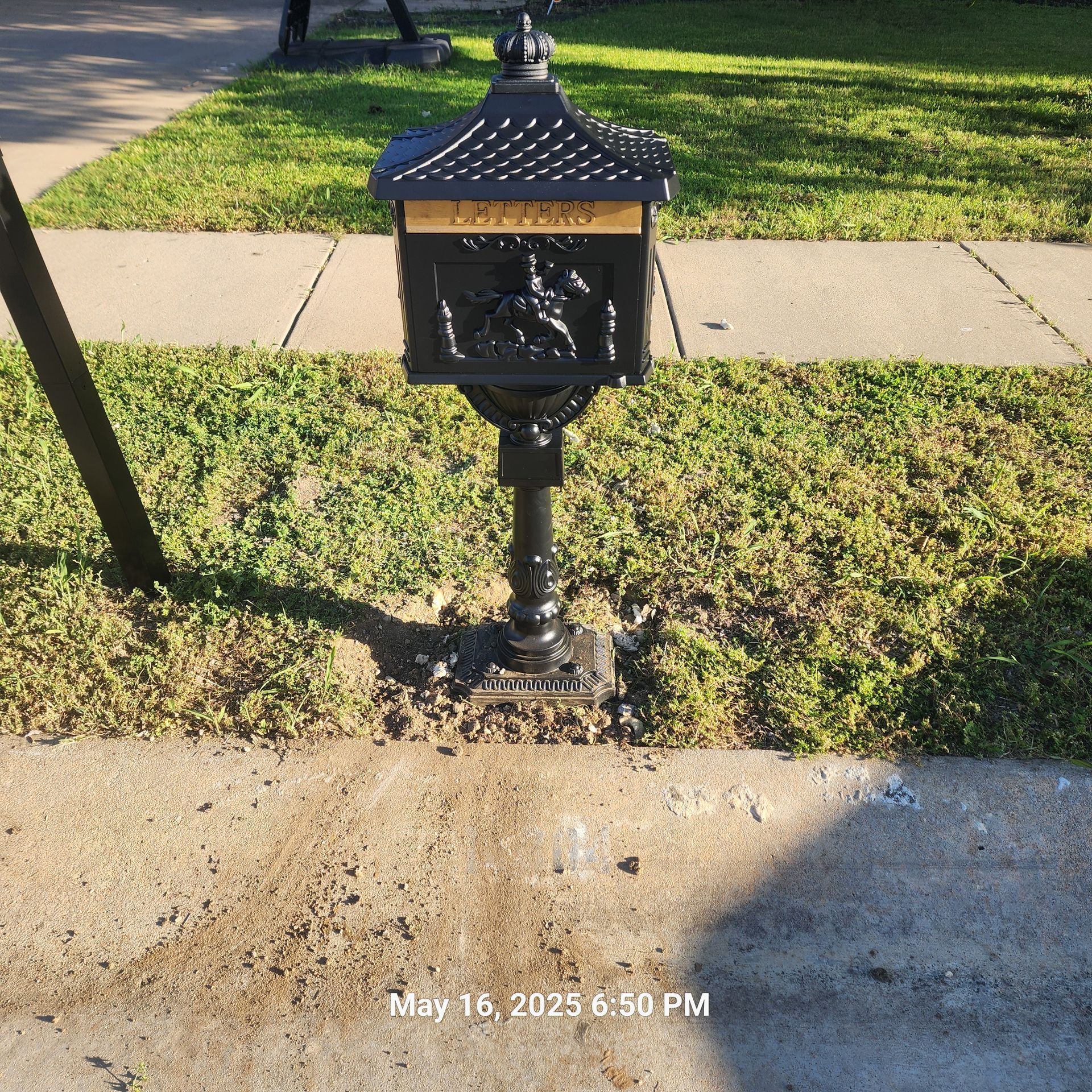A black mailbox with the word lost on it