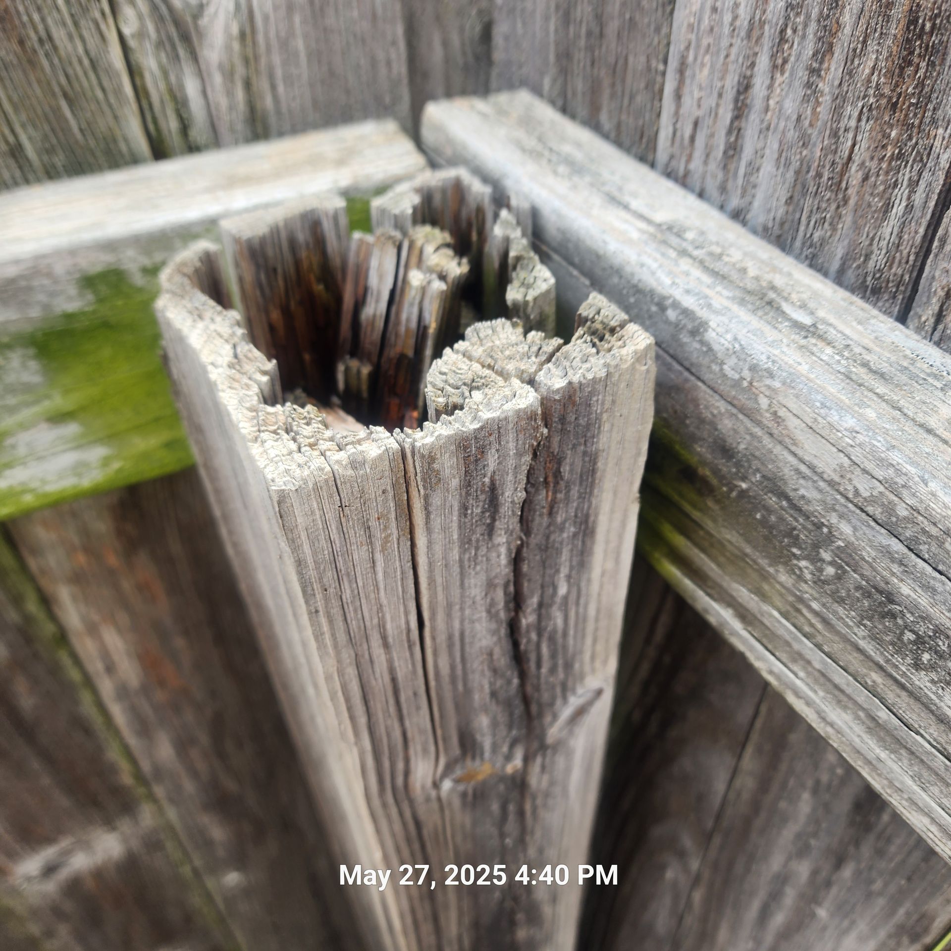 A picture of a wooden post taken on may 27th at 4:40 pm