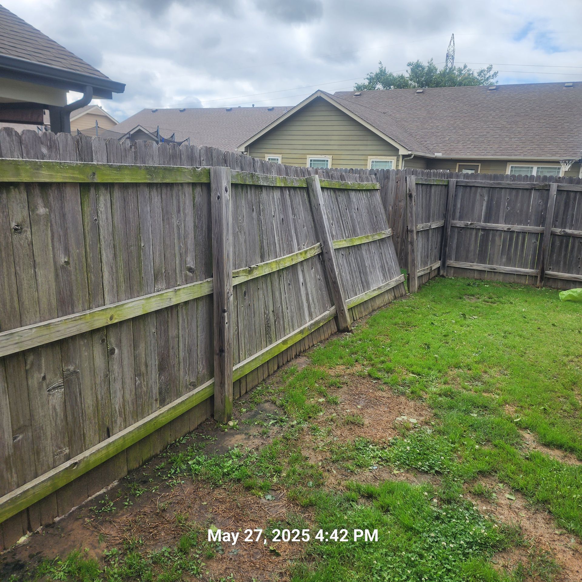 A picture of a wooden fence taken on may 27th at 4:42 pm