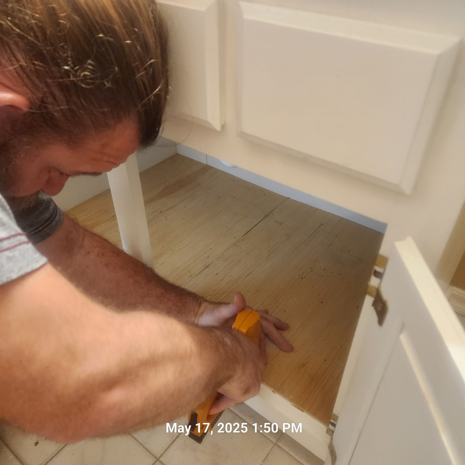 Fixing wood flooring of a cabinet.