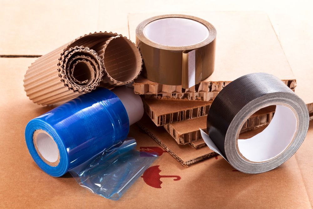 Several Rolls of Tape Are Sitting on Top of a Cardboard Box — Huskisson Self Storage in Huskisson, NSW