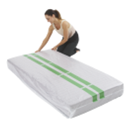 A Woman is Kneeling on a White Mattress With Green Stripes on It — Huskisson Self Storage in Huskisson, NSW
