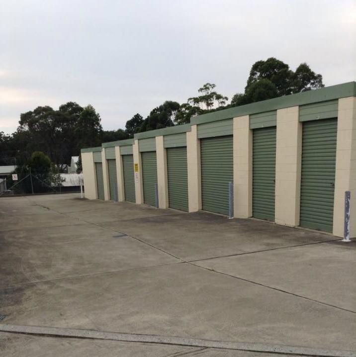 A Row of Green Garage Doors Are Lined Up in a Parking Lot — Huskisson Self Storage in Huskisson, NSW