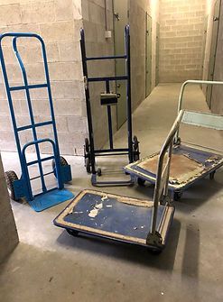 Three Hand Carts Are Sitting on the Floor in a Hallway — Huskisson Self Storage in Huskisson, NSW