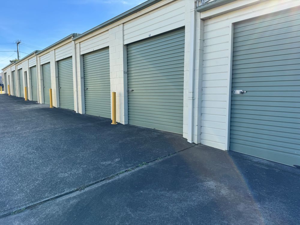 A Row of Garage Doors Are Lined Up in a Parking Lot — Huskisson Self Storage in Huskisson, NSW