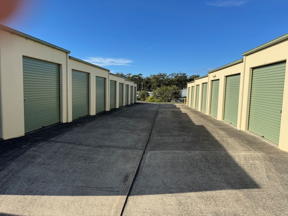 A Row of Garages With Green Doors on a Sunny Day — Huskisson Self Storage in Erowal Bay, NSW