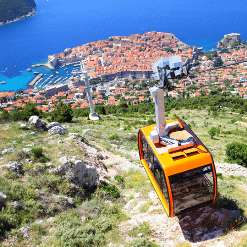 Arenal volcano, costa rica covered in clouds is surrounded by trees and mountains.
